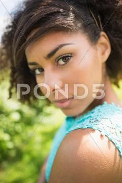 Gorgeous seductive brunette looking over shoulder at camera Stock Photos