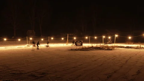 Gorgeous slow shutter shot of night pond hockey skaters Stock Footage 147405926