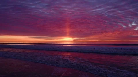 Gorgeous sunset at the beach over the ocean and birds flying Stock Footage 160809452