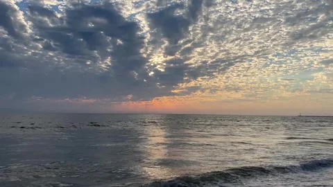 Gorgeous Sunset Over Beach Waves With Sun Rays Coming Out of Clouds HD Stock Footage 249986990