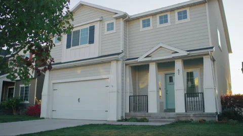 Gorgeous sunset push past tree reveal of white and gray craftsman house Vídeo Stock 242131707