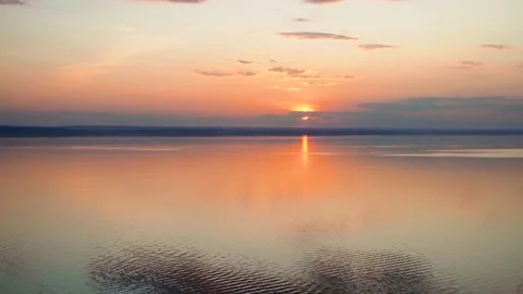 A gorgeous sunset on the sea with light waves with incredible colors Stock Footage 158927581