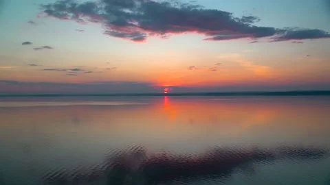 A gorgeous sunset on the sea with light waves with incredible colors Stock Footage 158927595