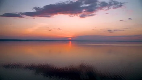 A gorgeous sunset on the sea with light waves with incredible colors Stock Footage 158927907