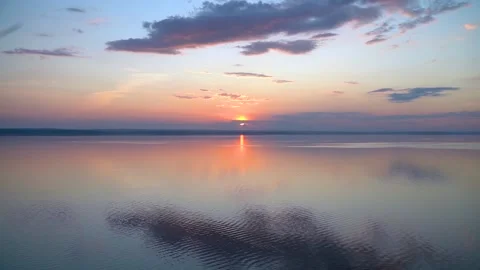 A gorgeous sunset on the sea with light waves with incredible colors Stock Footage 158927927