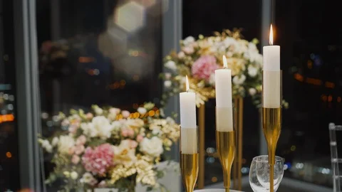 Gorgeous three candles in candlestick burning in a restaurant at night Stock Footage 125433507