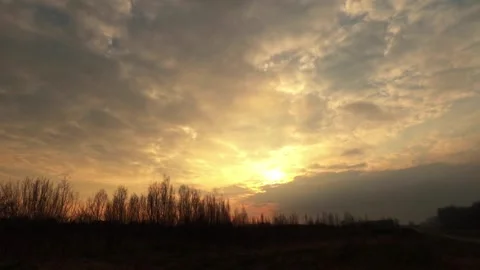 Gorgeous time-lapse footage captures the sun setting behind clouds Stock Footage 258609752