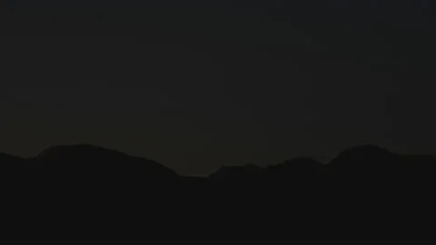 Gorgeous timelapse. Huge shadow move over mountains surface, reveal snowy summit Stock Footage 231642594
