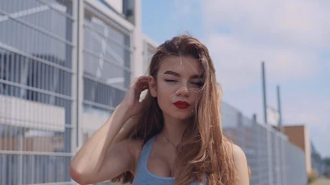 Gorgeous Ukrainian model walking down the street, looking at camera. Terrific Stock Footage 95960148
