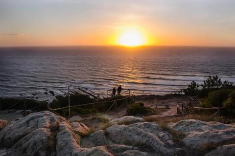 Gorgeous view of the sea with dramatic sunset, seen from a lovely and rocky Stock Photos