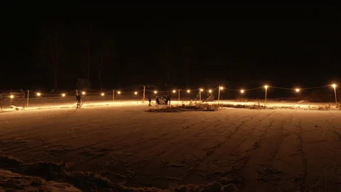 Gorgeous wide angle slow shutter shot of night pond hockey skaters Stock Footage 147406626