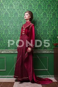 Gorgeous woman dressed in vintage clothes in retro interior Stock Photos