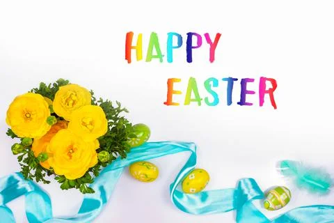 Gorgeous yellow ranunculus, easter Painted eggs, satin ribbon, delicate feath Stock Photos