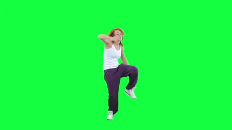 Gorgeous young energetic lady dancing isolated on green Stock Footage 57638742
