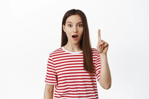 Got it, she has an idea. Young woman raise finger, pointing up, look with opened Photos