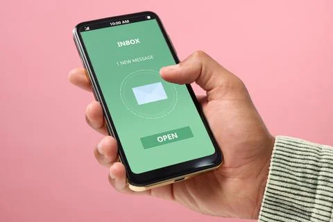 Got new message. Man using smartphone on pink background, closeup Stock Photos