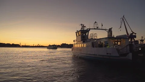 Gothenburg, Sweden - Oct 29, 2019 : Ferry passing river to Lindholmen at sunset Stock Footage