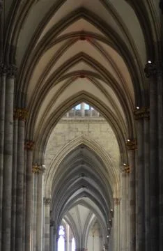 Gothic arches in a cathedral, leading to a window. Stock Photos