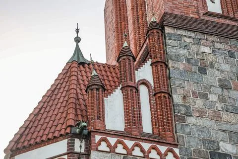 Gothic architecture detail with red tiled roof and gargoyle on a historic b.. Stock Photos