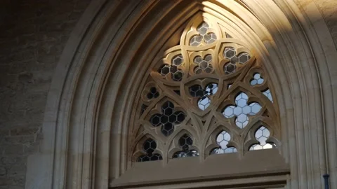 Gothic architecture detail of window arch with sunlight Stock Footage 212977459