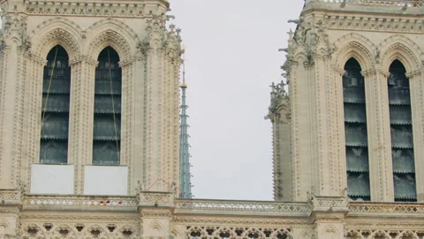 Gothic cathedral facade with arches, columns, and visible scaffolding Stock Footage 313462429
