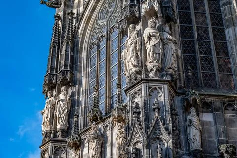 Gothic cathedral facade statues and stained glass window detail Stock Photos