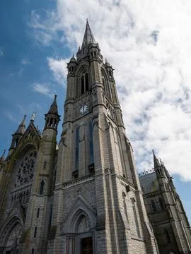 Gothic cathedral tower against a cloudy sky Stock Photos