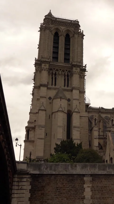 Gothic Cathedral Tower Rises Against Overcast Sky Seen From Street Level Stock Footage 334941053