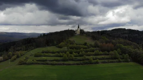 Gothic church on a hill with thunderclouds. Drone view Stock Footage 237349049