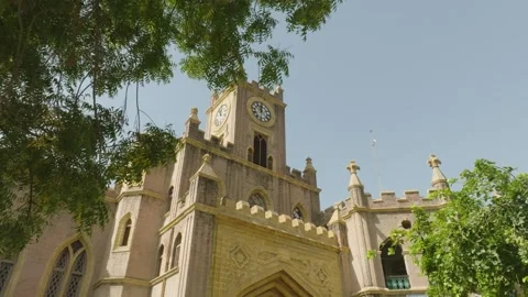 Gothic Clock Tower and Spires Framed by Trees Stock Footage 316903228