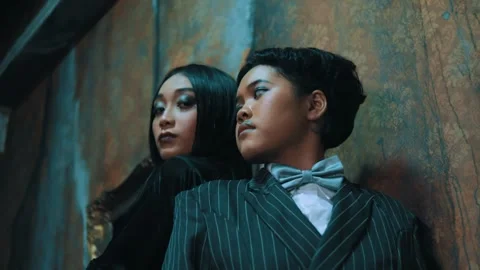 Gothic Couple Posing Against Old Wall, Looking Around Stock Footage 262935756