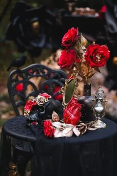 Gothic Halloween Table Setting with Skulls and Red Roses Stock Photos
