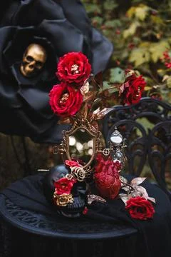 Gothic Halloween Table Setting with Skulls and Red Roses Stock Photos