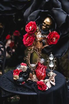 Gothic Halloween Table Setting with Skulls and Red Roses Stock Photos
