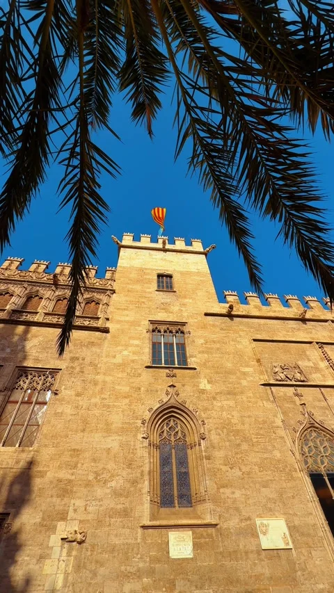 Gothic Silk Exchange building tower with flag through palms Stock Footage 328991994
