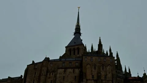 Gothic Spires and Stone Facade of Mont-Saint-Michel Abbey Against Overcast Sky 스톡 동영상 334157018