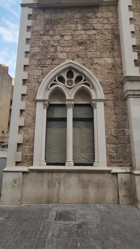 Gothic-style arched window on a building in Tripoli, Lebanon Stock Footage 314037276