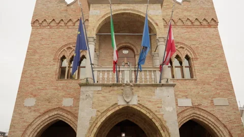 Gothic Town Hall facade with astronomical clock and colorful flags Stock Footage 325315030