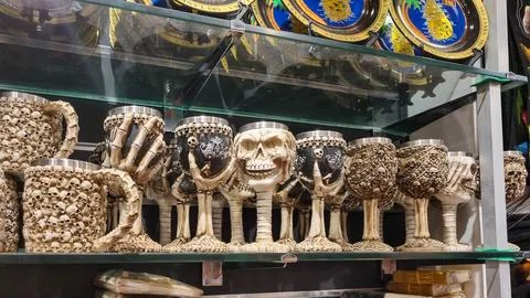Gothic wine goblets and tankards seen through a gothic themed shop window. .. Stock Photos