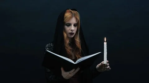 Gothic witch with book and candle Stock Footage 117548741