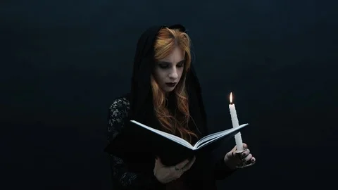Gothic witch with book and candle Stock Footage 117548787