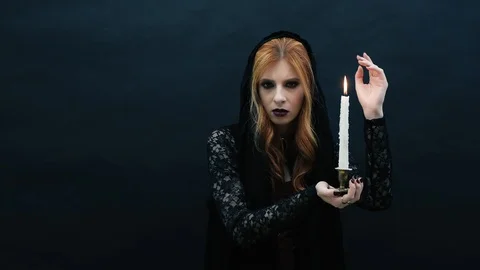 Gothic witch with candle on dark background Stock Footage 117537865