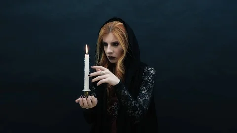 Gothic witch with candle on dark background Stock Footage 117538704