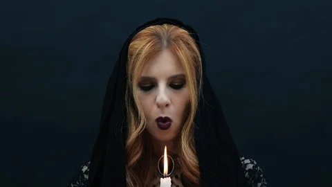 Gothic witch with candle on dark background Stock Footage 117547069