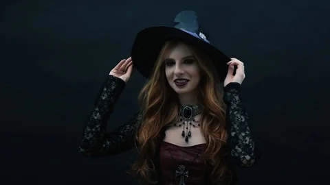 Gothic witch with hat on dark background Stock Footage 117545734