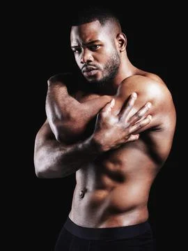 Gotta push through. Studio portrait of a fit young man posing against a black Stock Photos