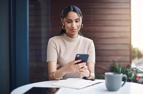 Gotta reply to this message quickly. an attractive young businesswoman sending a Stock Photos