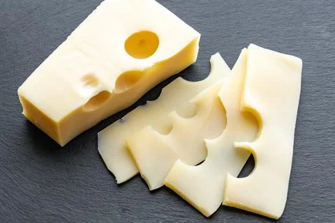 Gouda cheese on gray background. Gouda cheese slices Stock Photos