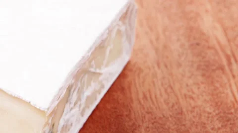 Gouda cheese on wooden table Stock Footage