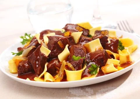 Goulash on pasta Stock Photos